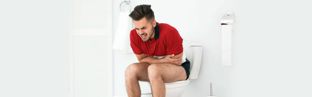 Man experiencing severe stomach pain due to diarrhea, emergency care needed.